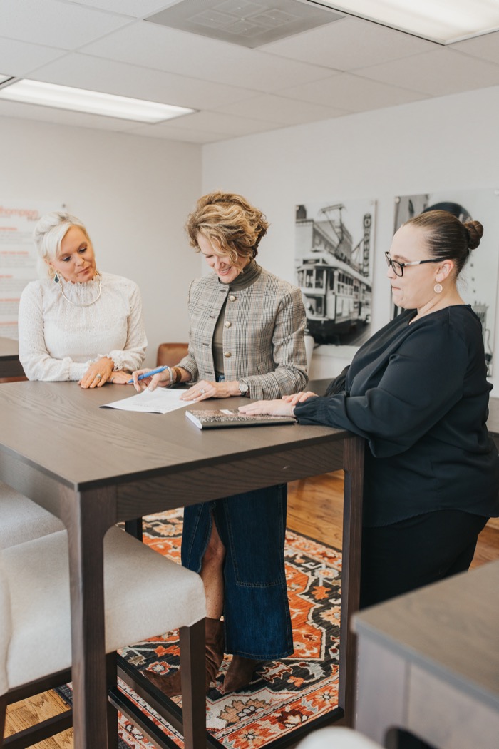 Melissa working with clients at the table
