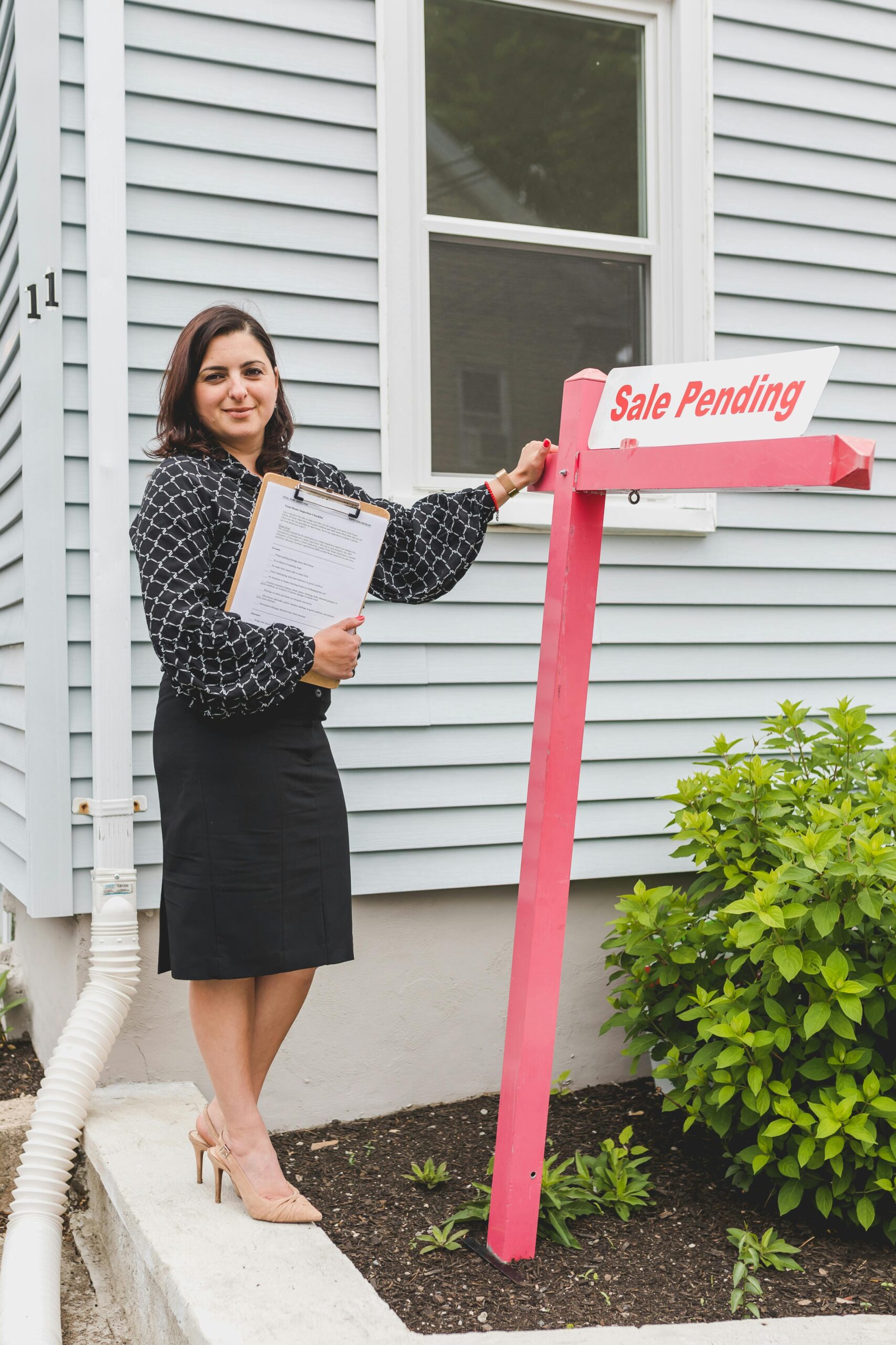 Agent with sale pending sign